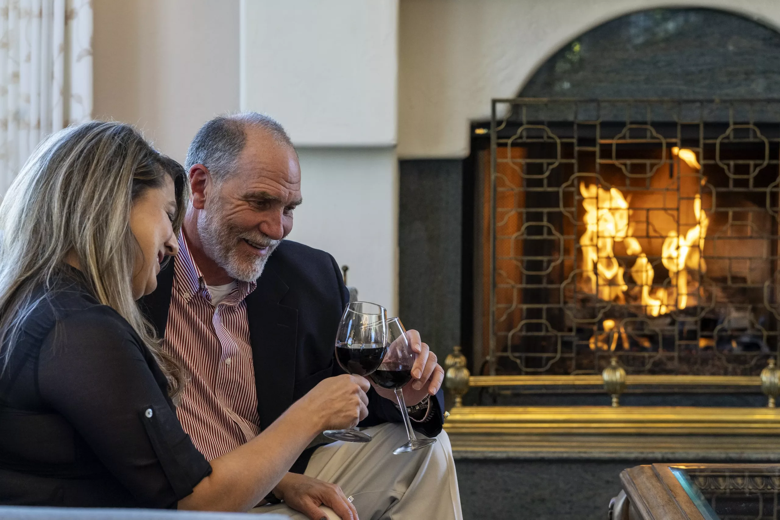 Couples drinking wine in the fireplace at Forest Villas Hotel in Prescott
