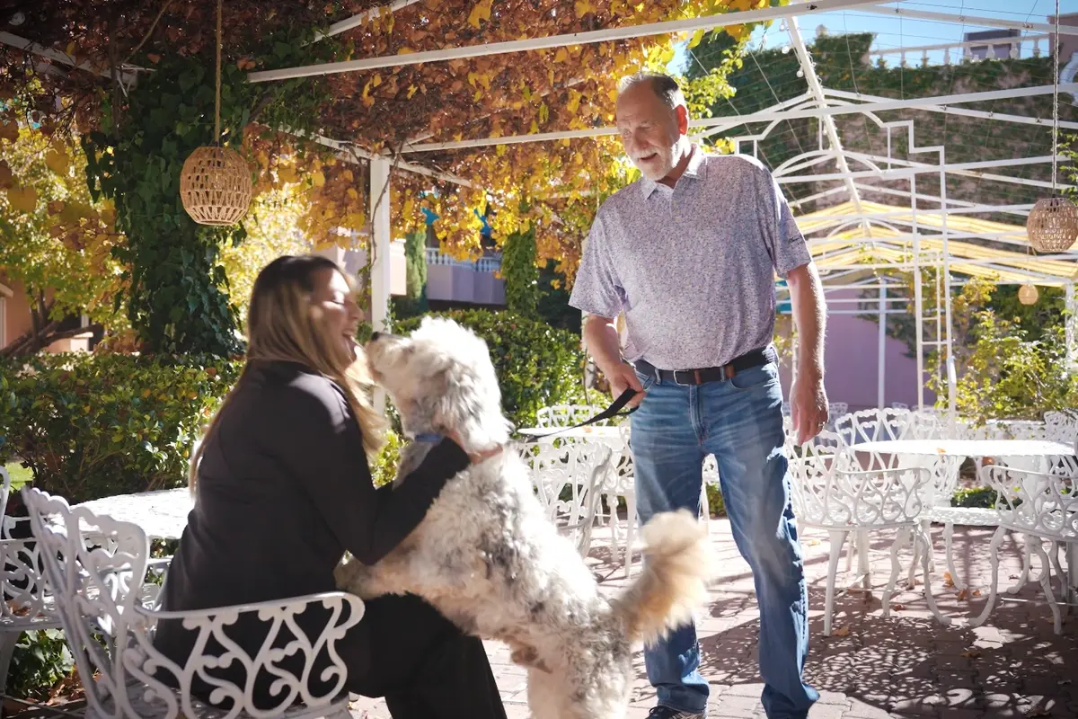 Dog greeting guest on patio at pet-friendly hotel in Prescott AZ