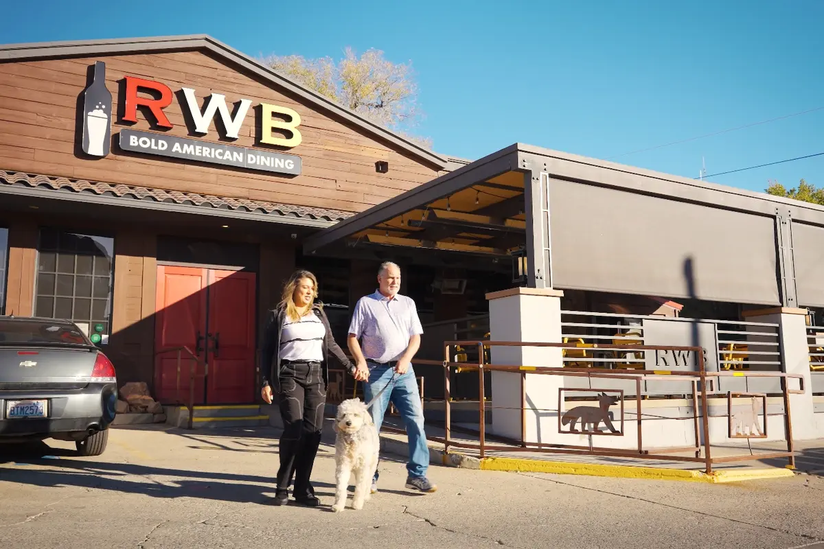 Guests with a dog at Red White and Brew, a pet-friendly restaurant near Forest Villas hotel in Prescott, AZ